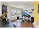 Home office featuring hardwood floors, two bright windows, and modern desk and chair at 7545 Azalea Cove Cir, Orlando, FL 32807