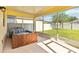 Screened in patio featuring a hot tub and views of the backyard at 7545 Azalea Cove Cir, Orlando, FL 32807