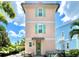 Peach home with a patio, table, and hot tub at 8001 Sand Bar Dr, Kissimmee, FL 34747