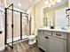 Bathroom features a walk in shower, wood like floors, and modern gray cabinets at 8001 Sand Bar Dr, Kissimmee, FL 34747