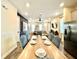 Open-concept dining area with seating for six, connecting the living room and kitchen at 8001 Sand Bar Dr, Kissimmee, FL 34747