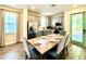 Bright dining area with a large table, seating for six, and access to a modern kitchen at 8001 Sand Bar Dr, Kissimmee, FL 34747
