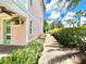 Home exterior featuring walkway with lush green landscaping at 8001 Sand Bar Dr, Kissimmee, FL 34747
