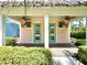Cozy peach colored house featuring double doors, fans and shutters at 8001 Sand Bar Dr, Kissimmee, FL 34747