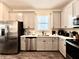 Well-appointed kitchen with stainless steel appliances, bright countertops, and stylish cabinets at 8001 Sand Bar Dr, Kissimmee, FL 34747
