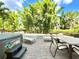 Relaxing patio area with spa, lounge chairs and dining set, perfect for outdoor entertaining at 8001 Sand Bar Dr, Kissimmee, FL 34747