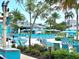 Relaxing community pool area with plenty of lounge chairs, umbrellas, and lush landscaping at 8001 Sand Bar Dr, Kissimmee, FL 34747