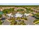 Aerial view of a community clubhouse with a pool surrounded by palm trees and well-manicured landscaping at 8160 Sun Palm Dr, Kissimmee, FL 34747
