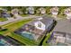 Aerial view of a well-maintained home with a large screened pool enclosure and lush landscaping at 8160 Sun Palm Dr, Kissimmee, FL 34747