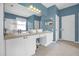 Bathroom with double sinks, a large mirror, and vanities with plenty of storage at 8160 Sun Palm Dr, Kissimmee, FL 34747