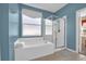 Bathroom with a soaking tub and glass enclosed shower at 8160 Sun Palm Dr, Kissimmee, FL 34747