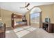 Bedroom features bunk bed, large window, ceiling fan, and beige walls at 8160 Sun Palm Dr, Kissimmee, FL 34747
