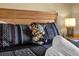 Close-up showcasing the bed with a giraffe plush, decorative pillows, and bedside table with a lamp at 8160 Sun Palm Dr, Kissimmee, FL 34747