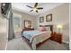 Comfortable bedroom features a ceiling fan, window, and neutral wall color at 8160 Sun Palm Dr, Kissimmee, FL 34747