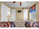 Spacious bedroom featuring twin beds, ceiling fan, and a mounted television for entertainment at 8160 Sun Palm Dr, Kissimmee, FL 34747