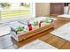 Close up of a dining room table with a wooden centerpiece and small plants at 8160 Sun Palm Dr, Kissimmee, FL 34747