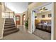 Open foyer showcasing a staircase, tile flooring, and an arched doorway leading to another room at 8160 Sun Palm Dr, Kissimmee, FL 34747