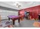 Spacious game room featuring a pool table, foosball table, and an arcade game for endless fun at 8160 Sun Palm Dr, Kissimmee, FL 34747