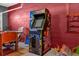 Arcade game adds a fun touch to this colorful game room with a red brick wall at 8160 Sun Palm Dr, Kissimmee, FL 34747