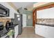 Well lit kitchen with a refrigerator, tile floors, granite countertops, and stainless steel appliances at 8160 Sun Palm Dr, Kissimmee, FL 34747