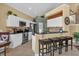 Modern kitchen with white cabinets, stainless steel appliances, and breakfast bar at 8160 Sun Palm Dr, Kissimmee, FL 34747