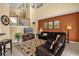 Comfortable living room with leather sofa, decorative rug, and staircase view at 8160 Sun Palm Dr, Kissimmee, FL 34747