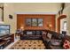 Bright living room with brown leather sofa, warm lighting, and cozy Mickey Mouse themed rug at 8160 Sun Palm Dr, Kissimmee, FL 34747