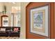 View of living room showing leather furniture, an adjacent pool, and wall art from an arched doorway at 8160 Sun Palm Dr, Kissimmee, FL 34747