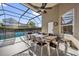 The screened patio features a dining table with seating for eight and a ceiling fan at 8160 Sun Palm Dr, Kissimmee, FL 34747
