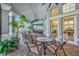 Outdoor patio seating area featuring lush tropical plants and comfortable furniture at 8160 Sun Palm Dr, Kissimmee, FL 34747