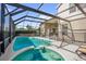 The screened pool area includes a spa, covered patio, and ample space for outdoor enjoyment at 8160 Sun Palm Dr, Kissimmee, FL 34747