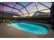 Inviting screened pool and spa surrounded by lush landscaping offers a private backyard oasis at sunset at 8160 Sun Palm Dr, Kissimmee, FL 34747