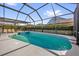 Inviting screened pool and spa surrounded by lush landscaping offers a private backyard oasis at 8160 Sun Palm Dr, Kissimmee, FL 34747