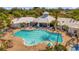 Aerial view of the community pool with lounge chairs and umbrellas at 8160 Sun Palm Dr, Kissimmee, FL 34747