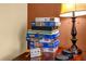 A stack of puzzles sits on a side table next to a lamp in this room at 8160 Sun Palm Dr, Kissimmee, FL 34747