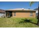 Backyard view reveals home's exterior with a screened in porch at 8856 Hastings Beach Blvd, Orlando, FL 32829