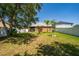 Green grass backyard with white vinyl fence, shade tree and manicured landscaping at 8856 Hastings Beach Blvd, Orlando, FL 32829