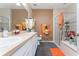 Well-lit bathroom featuring a double vanity, glass-enclosed shower, and separate tub at 8856 Hastings Beach Blvd, Orlando, FL 32829