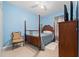 Cozy bedroom featuring light blue walls, four poster bed, and tile flooring at 8856 Hastings Beach Blvd, Orlando, FL 32829
