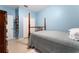 A cozy bedroom with a four poster bed, and neutral tile flooring at 8856 Hastings Beach Blvd, Orlando, FL 32829