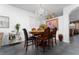Elegant dining room with a chandelier and decorative accents, with seating for six at 8856 Hastings Beach Blvd, Orlando, FL 32829