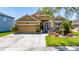 Charming tan home with landscaped front yard and decorative fountain on a sunny day at 8856 Hastings Beach Blvd, Orlando, FL 32829