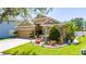Attractive home with a well-maintained lawn and charming front garden featuring a water fountain at 8856 Hastings Beach Blvd, Orlando, FL 32829