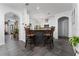 Open-concept kitchen with island seating, white cabinetry, and an elegant chandelier at 8856 Hastings Beach Blvd, Orlando, FL 32829