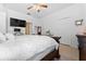Bright main bedroom featuring a plush bed, ceiling fan, and access to bathroom at 8856 Hastings Beach Blvd, Orlando, FL 32829