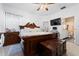 Spacious main bedroom showcasing a large bed, wooden furnishings, and bathroom entrance at 8856 Hastings Beach Blvd, Orlando, FL 32829