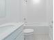 Bathroom showcasing a bathtub, toilet, and modern vanity with a quartz countertop at 917 Jackson Ave, Davenport, FL 33837