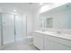 Bathroom with double sink vanity, shower, and large mirror at 917 Jackson Ave, Davenport, FL 33837