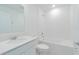 Well-lit bathroom with a modern vanity, quartz countertop, and a shower-tub combination at 917 Jackson Ave, Davenport, FL 33837