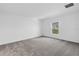 Neutral bedroom featuring a window for natural light and plush carpeting at 917 Jackson Ave, Davenport, FL 33837